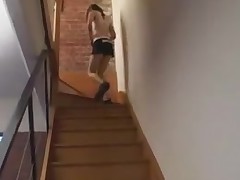 Adorable unshaven girl shows off on a stairway